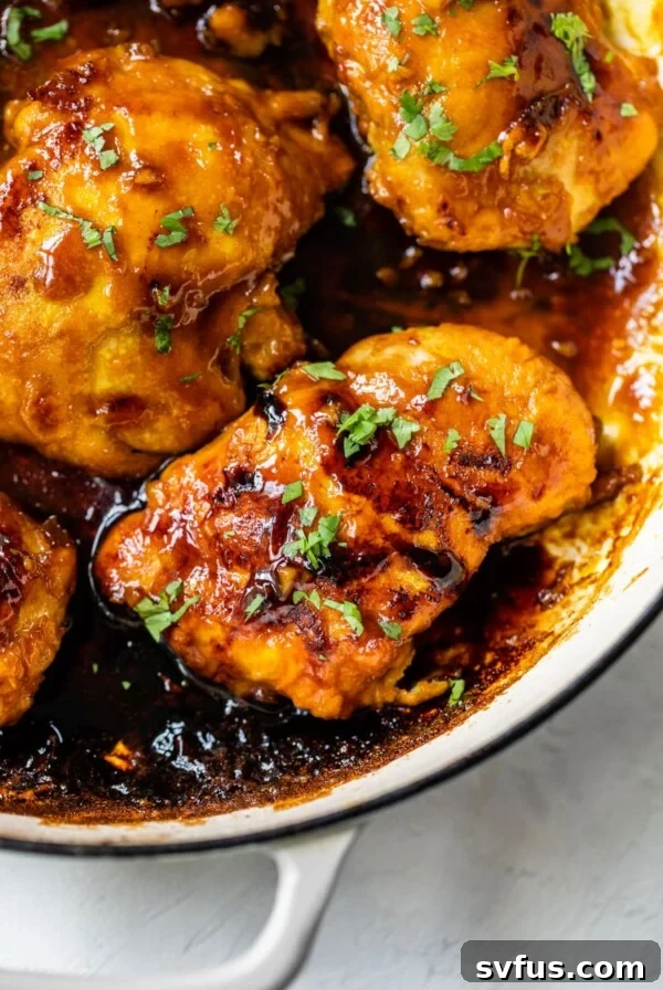 cooked chicken thighs in a skillet with sauce